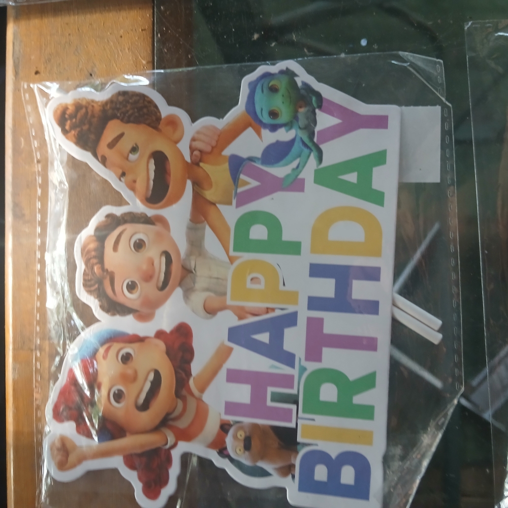 Colorful Birthday Cake Topper And Other Items For A Themed Party